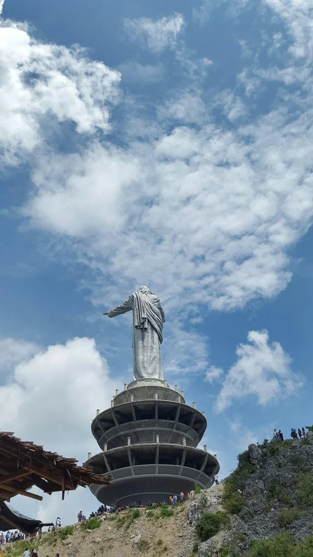 The hilltop statue of Christ at Buntu Burake against cloud