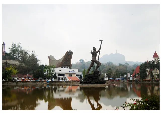 The lake at Makale with its statue and tongkonan-roofed buildings